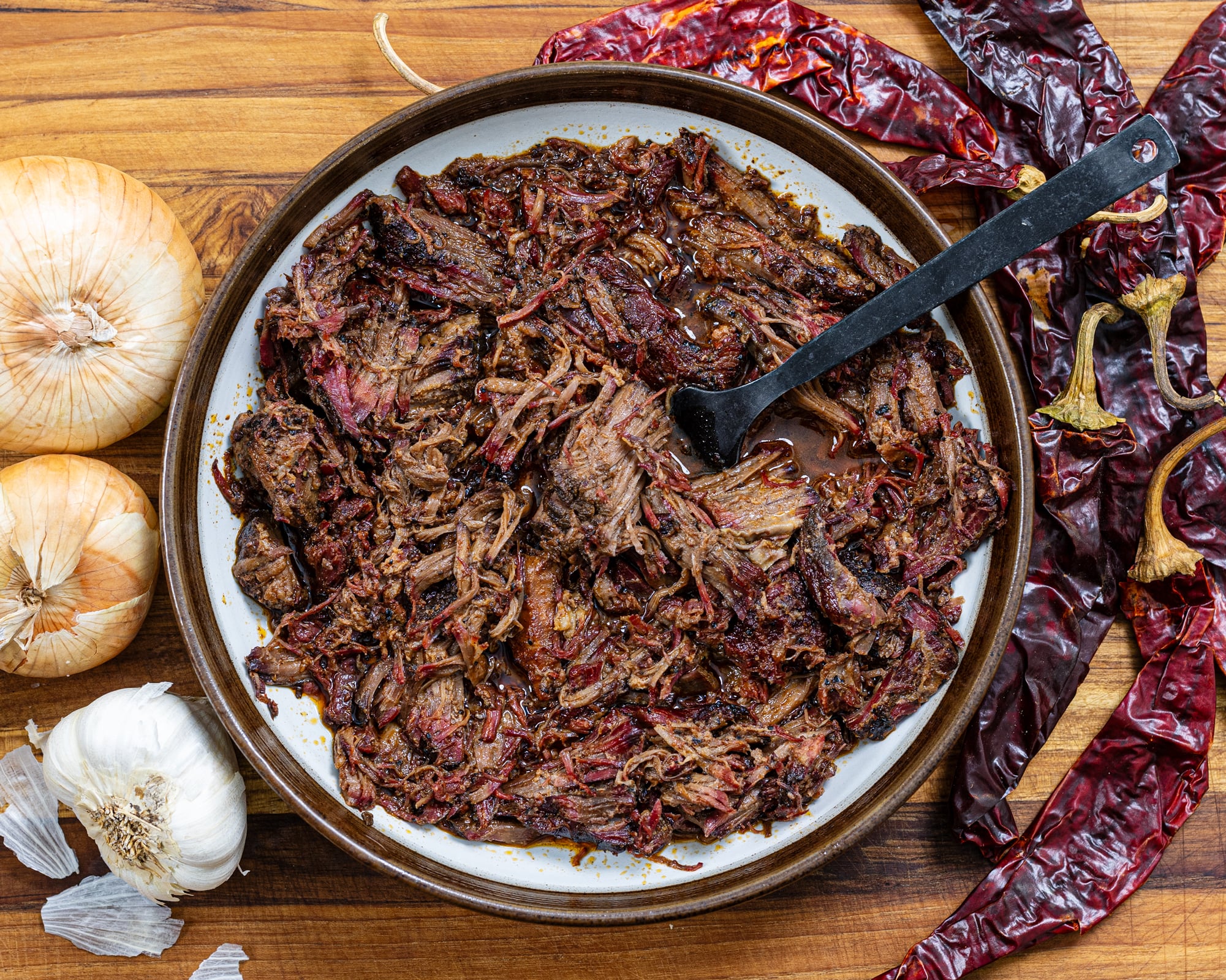 Homemade smoked barbacoa seasoned with adobo sauce and shredded until tender.