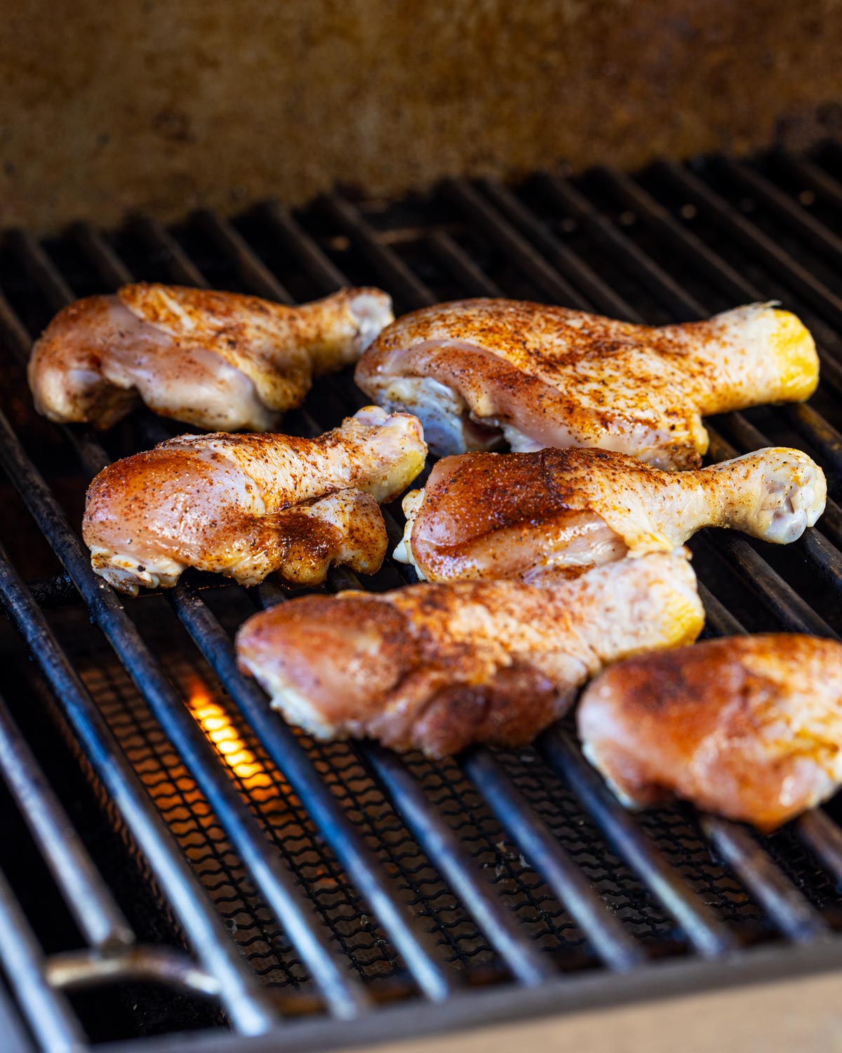 Grilling the seasoned butterflied chicken drumsticks