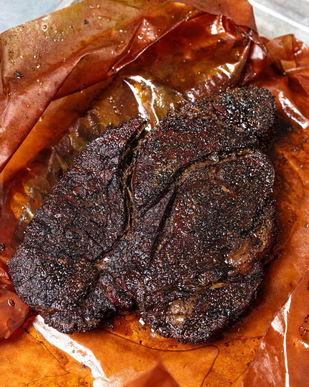 Smoked chuck roast resting in butcher paper after the cook