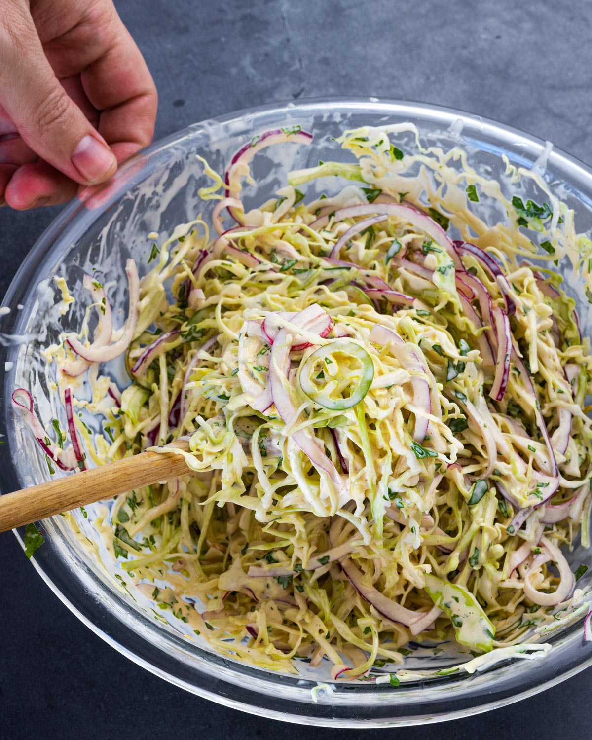 Mixing all of the ingredients for this southwest slaw recipe