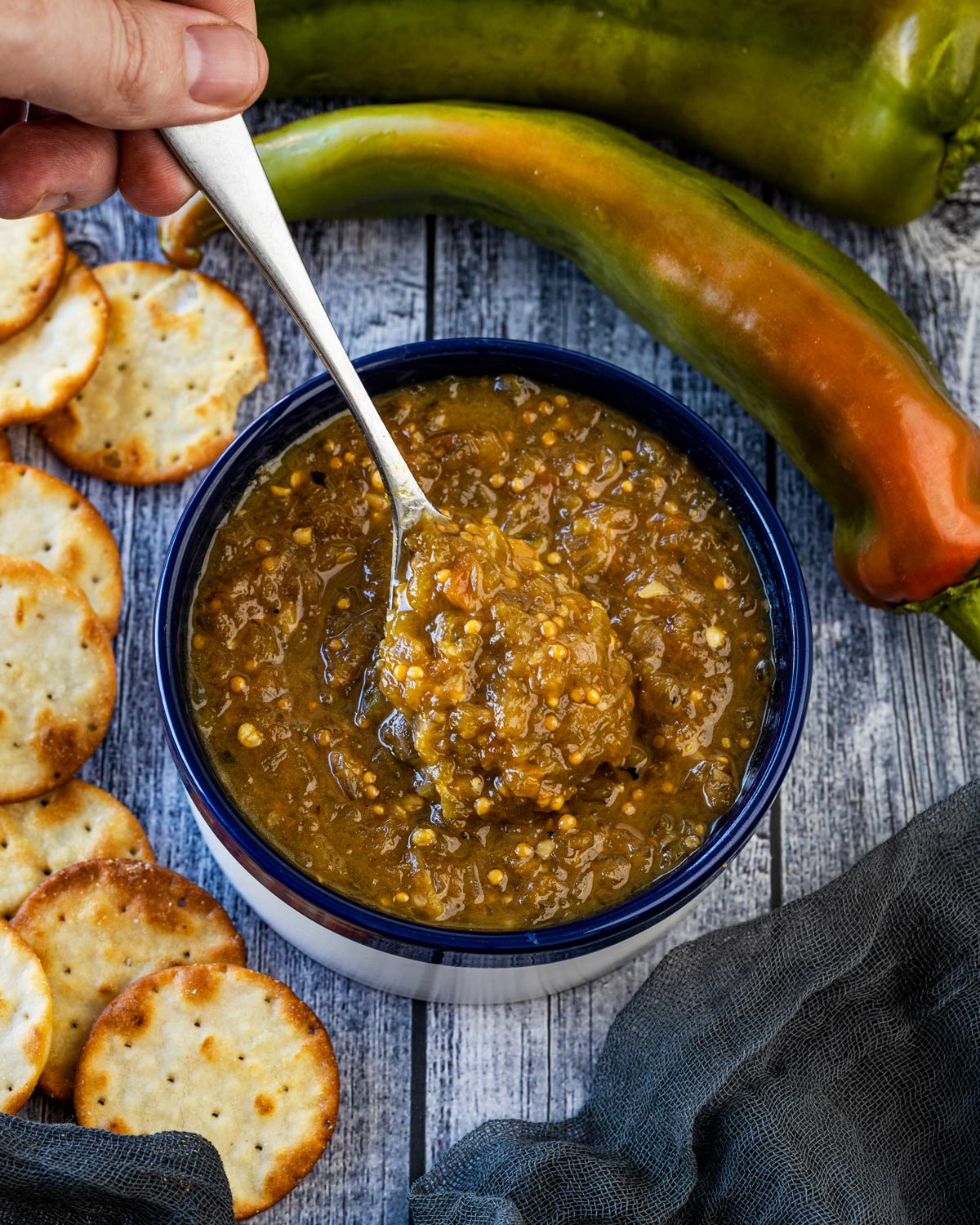 Hatch chile jam in a bowl with chiles and crackers