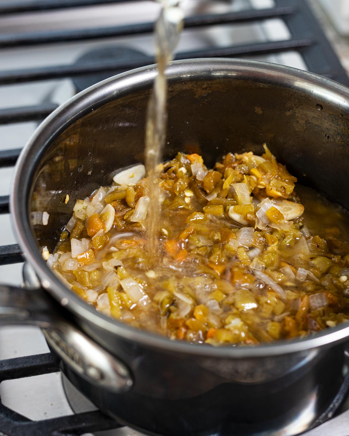 Deglazing the pan with apple juice before simmering.