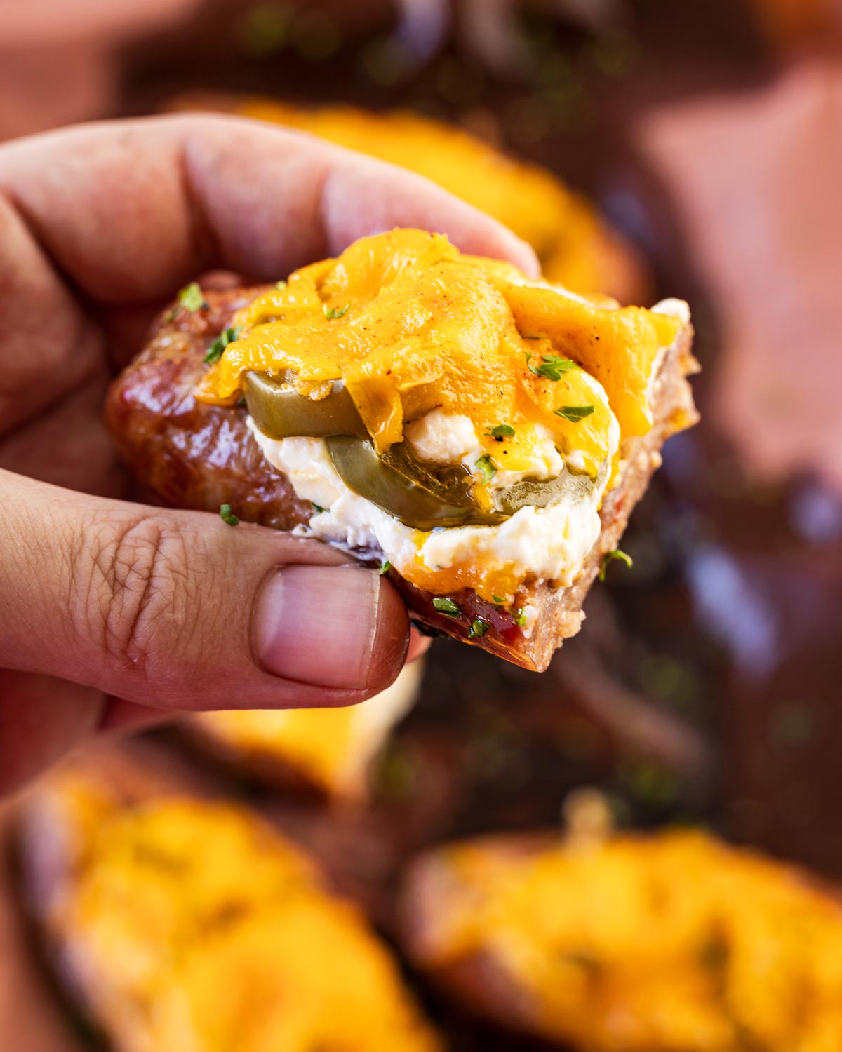 Take a bite of this sliced sausage boat with cream cheese dripping out.