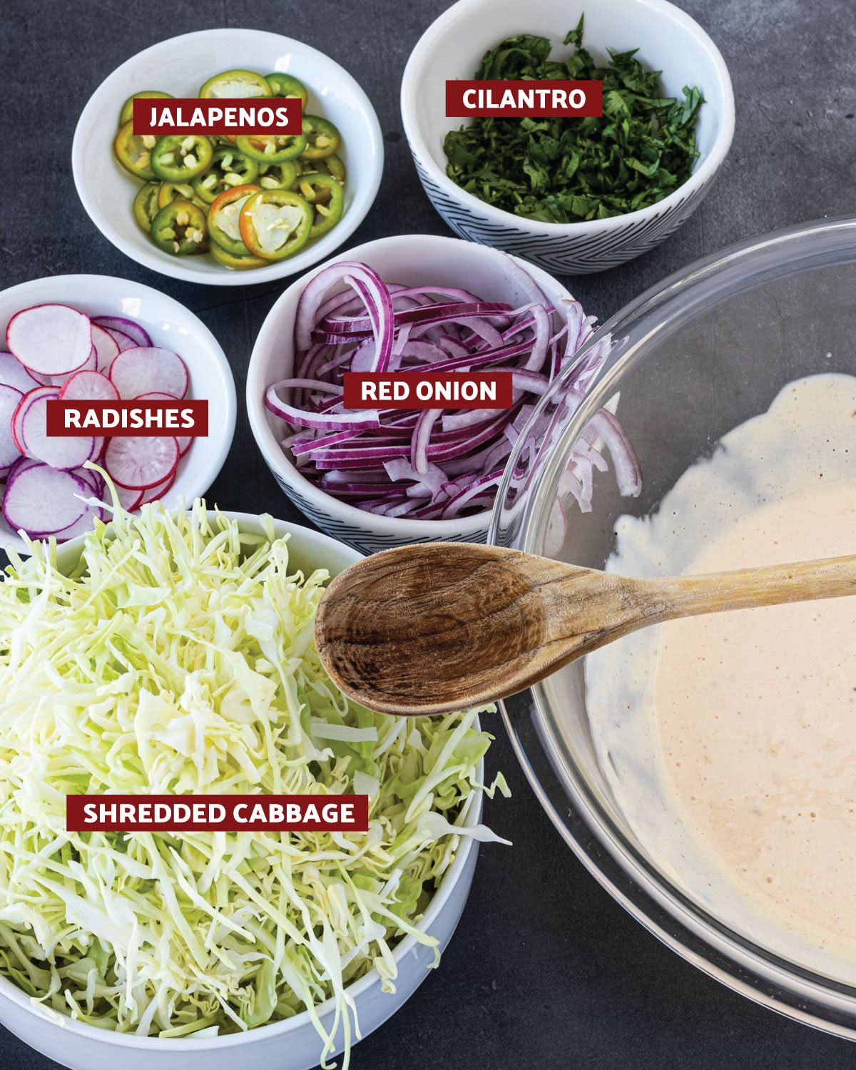 Cabbage, red onion, dressing, and other veggies for the slaw