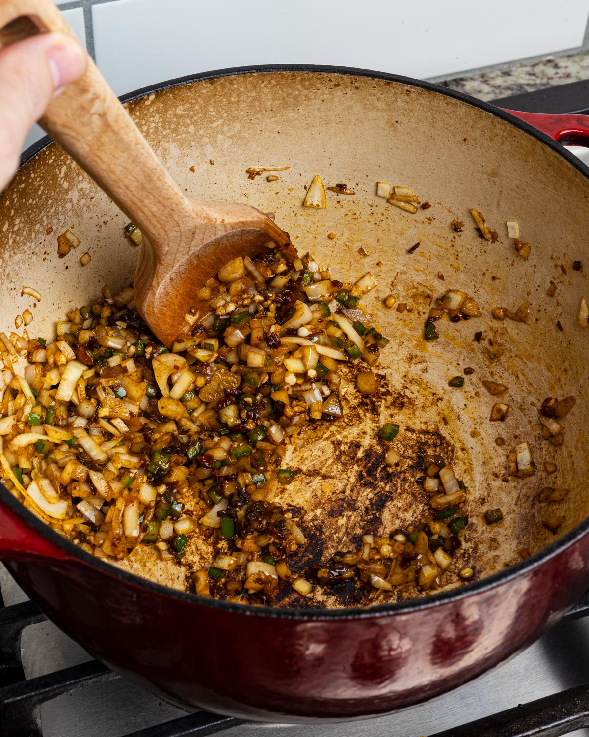Add the jalapenos and onions to the bacon fat, then the chopped chipotles.