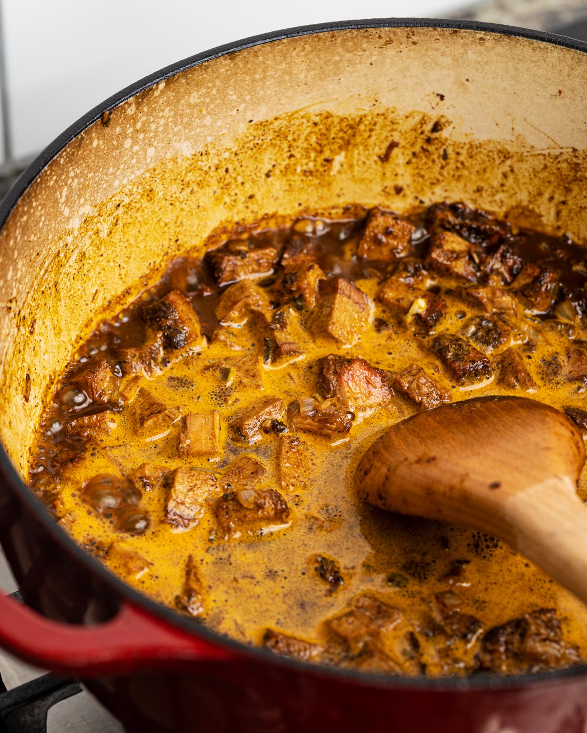 Deglaze the pot with room temperature beer and bring to a simmer to cook off some of the alcohol.