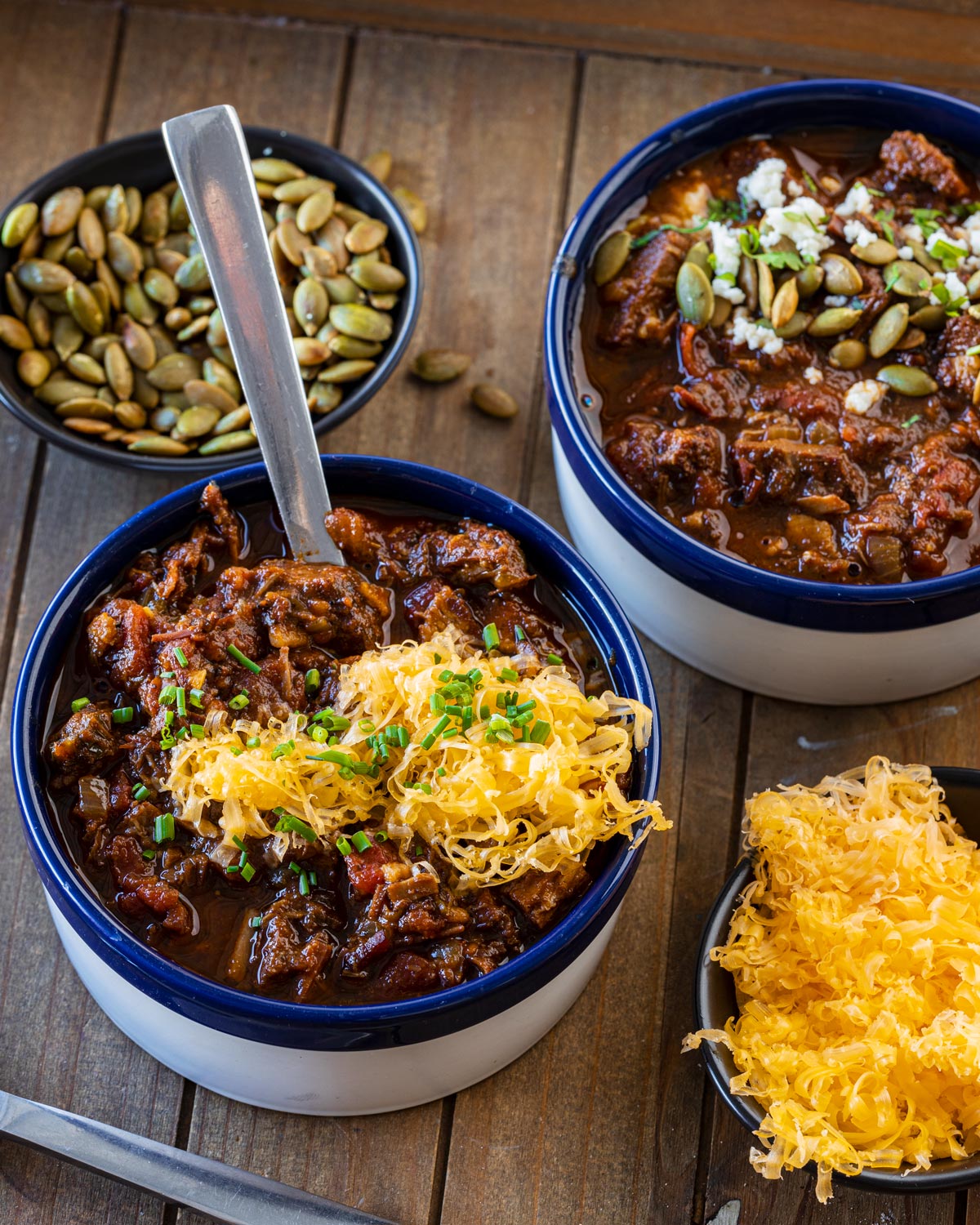 Smoked Texas brisket chili topped with shredded cheddar and chives