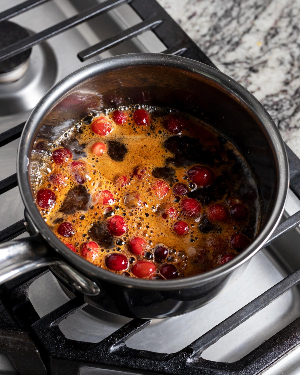 Cooking down the cranberries in the liquids before blending.