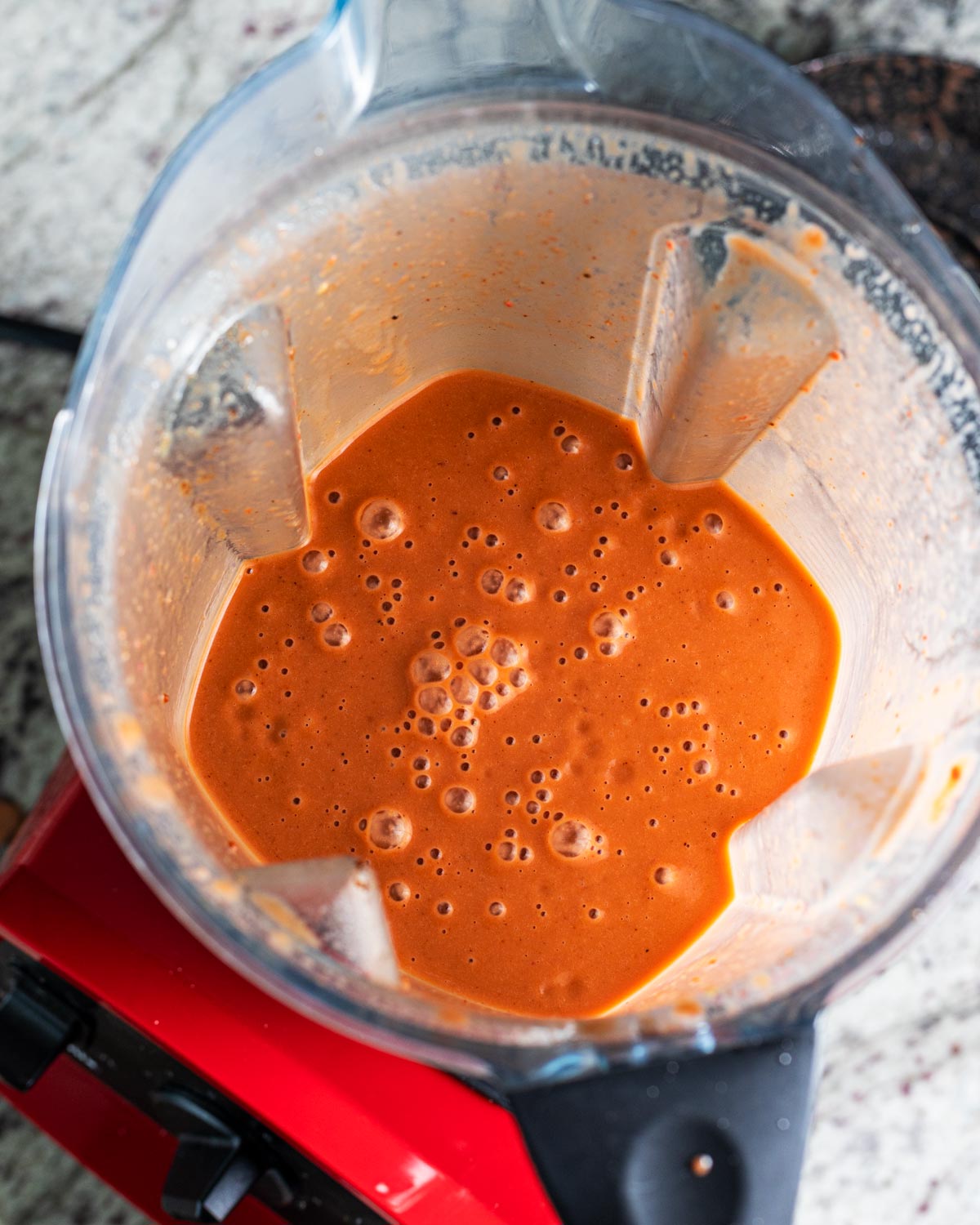 Stream in the oil slowly while blending at the end to emulsify the ingredients, creating a smooth sauce.
