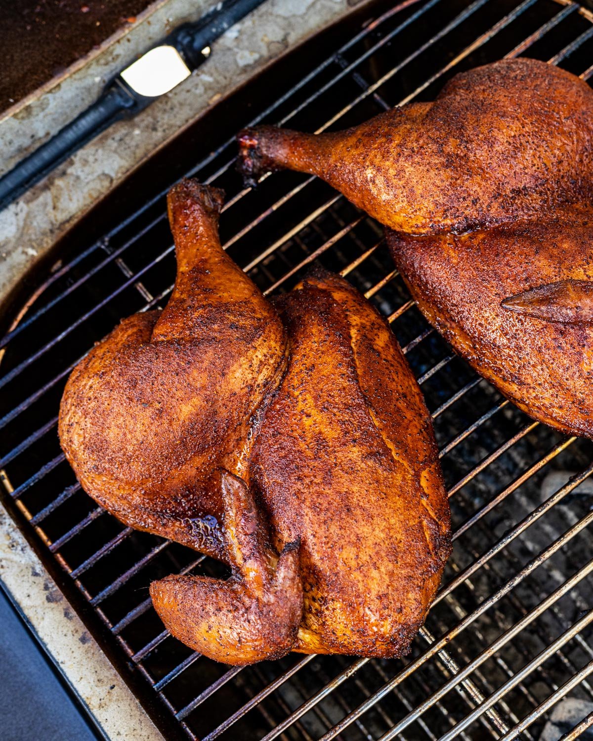 Smoked chicken halves are cooked right on the grates, not enough room for a wire rack.