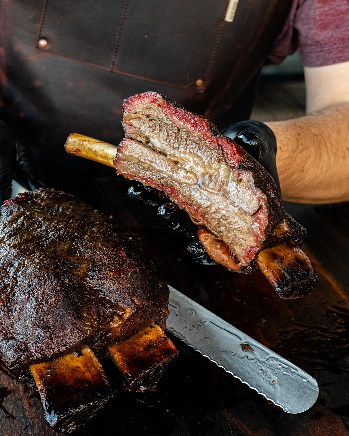 Slicing a beef rib to serve.