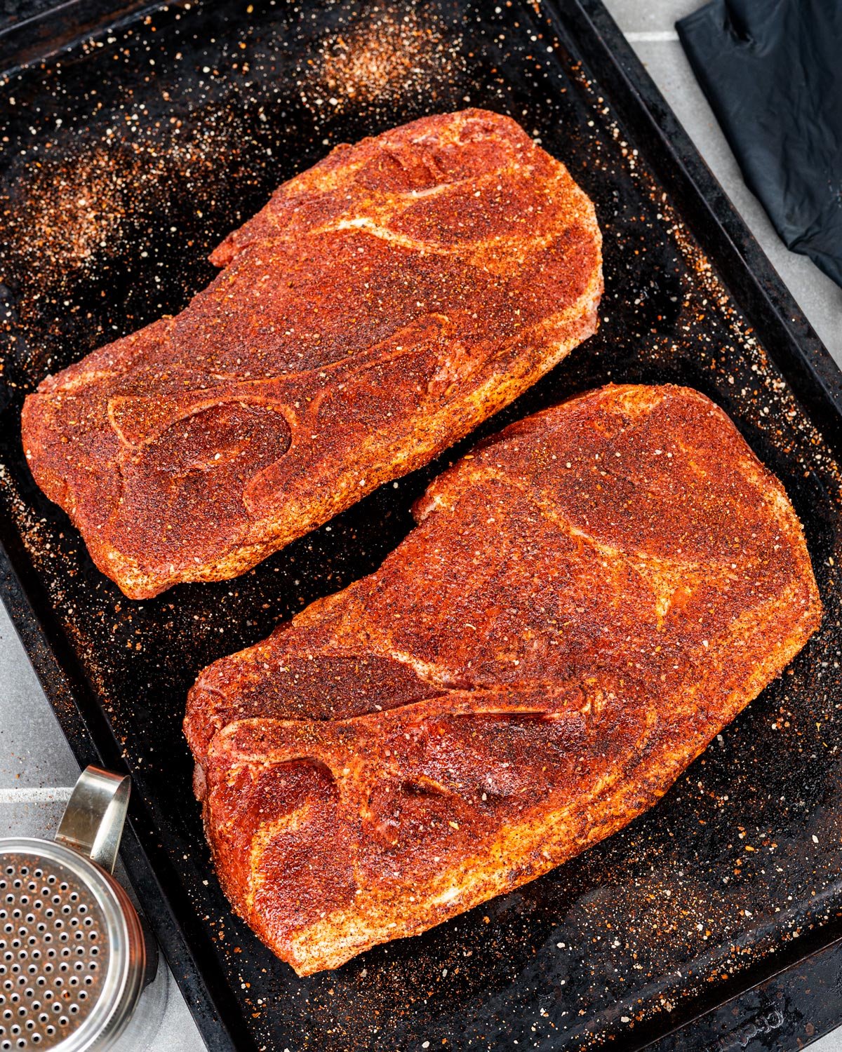 Season the pork steaks generously on all sides, allowing them to rest for about 30 minutes.
