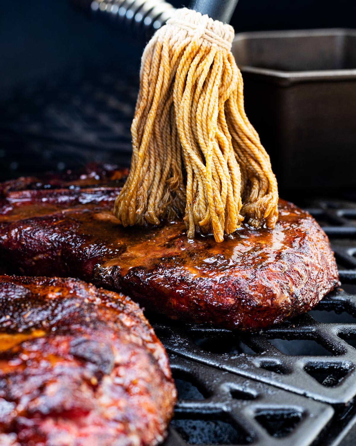 Mop the pork steaks with a sweet and savory sauce to help retain moisture.