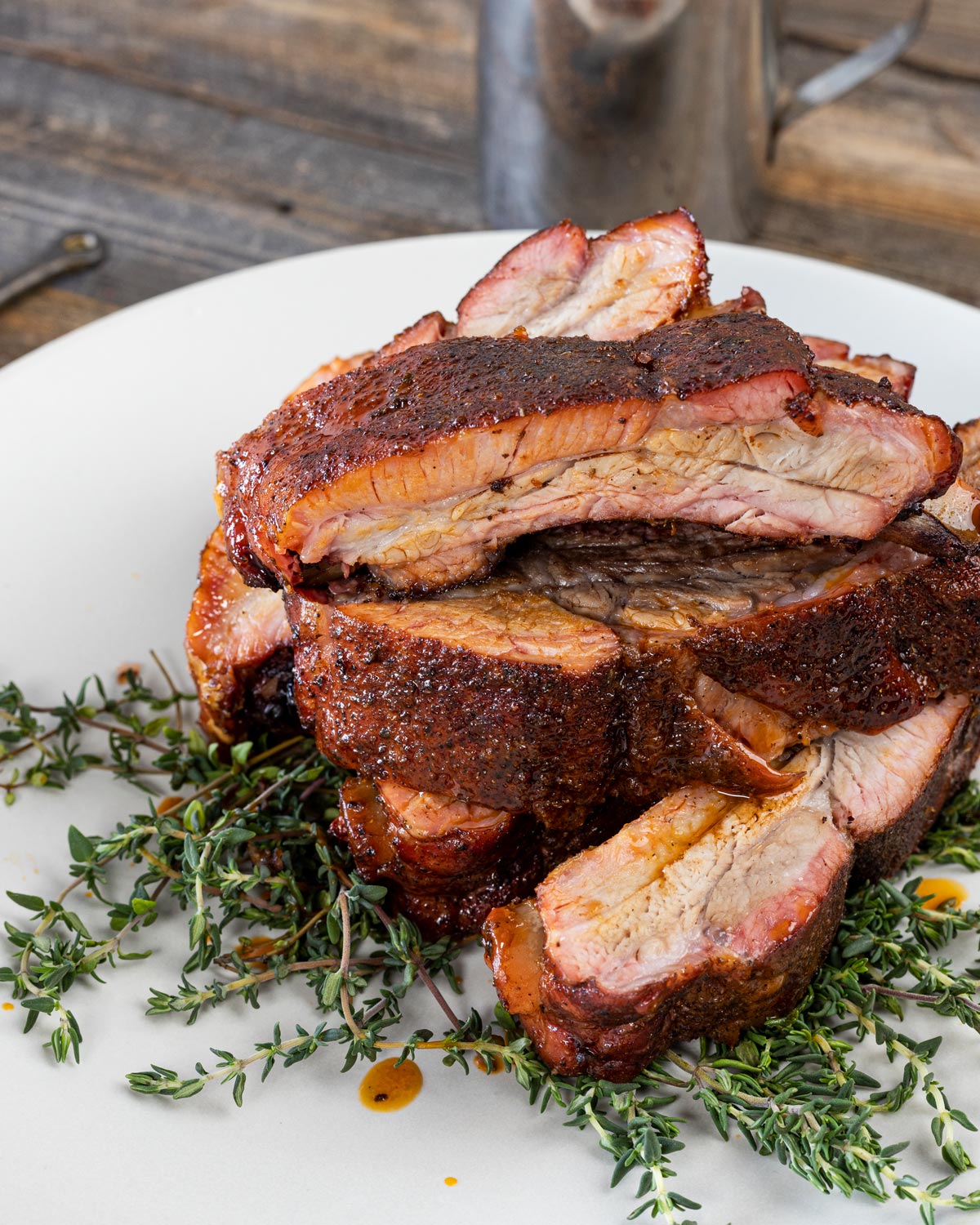 Juicy Cajun pork ribs are served over a bed of fresh thyme.