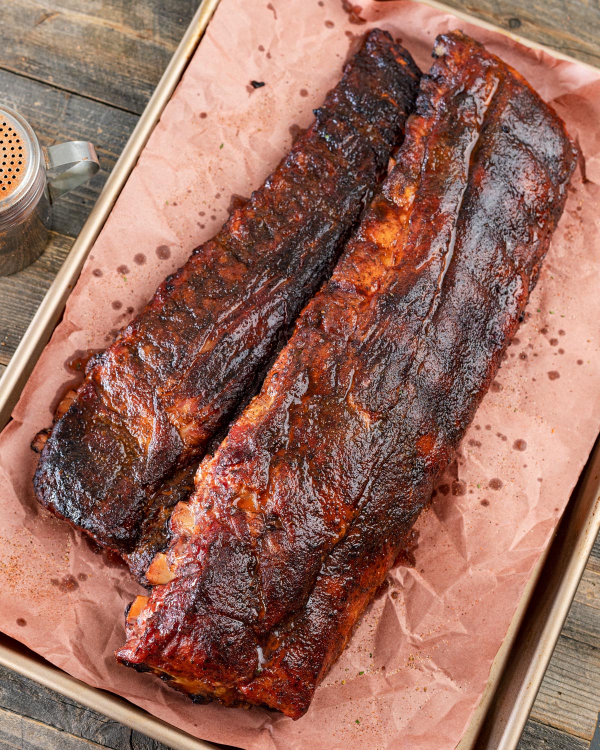 Smoked Cajun pork ribs are fresh off the smoker and ready to be sliced.