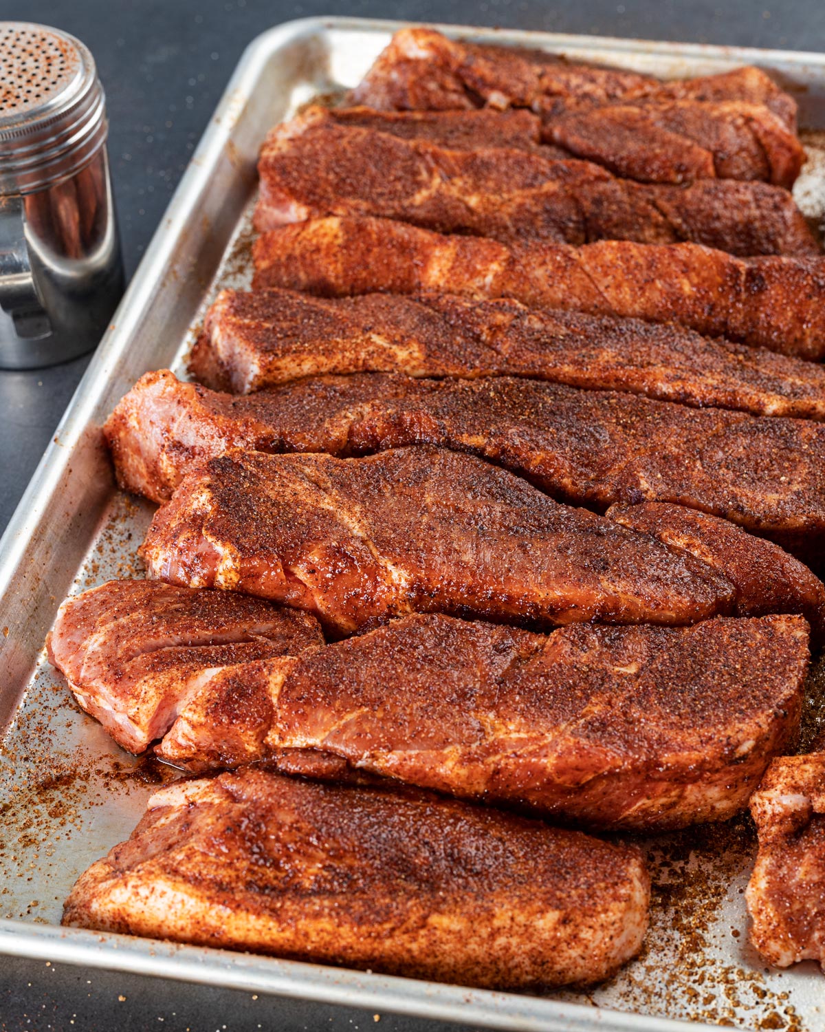 Season the pork generously on all sides with the dry rub.