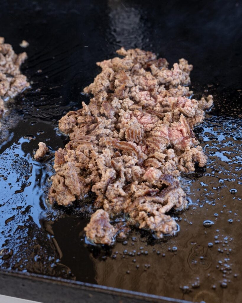Chop the seared beef and chipotle chiles to cook everything through.