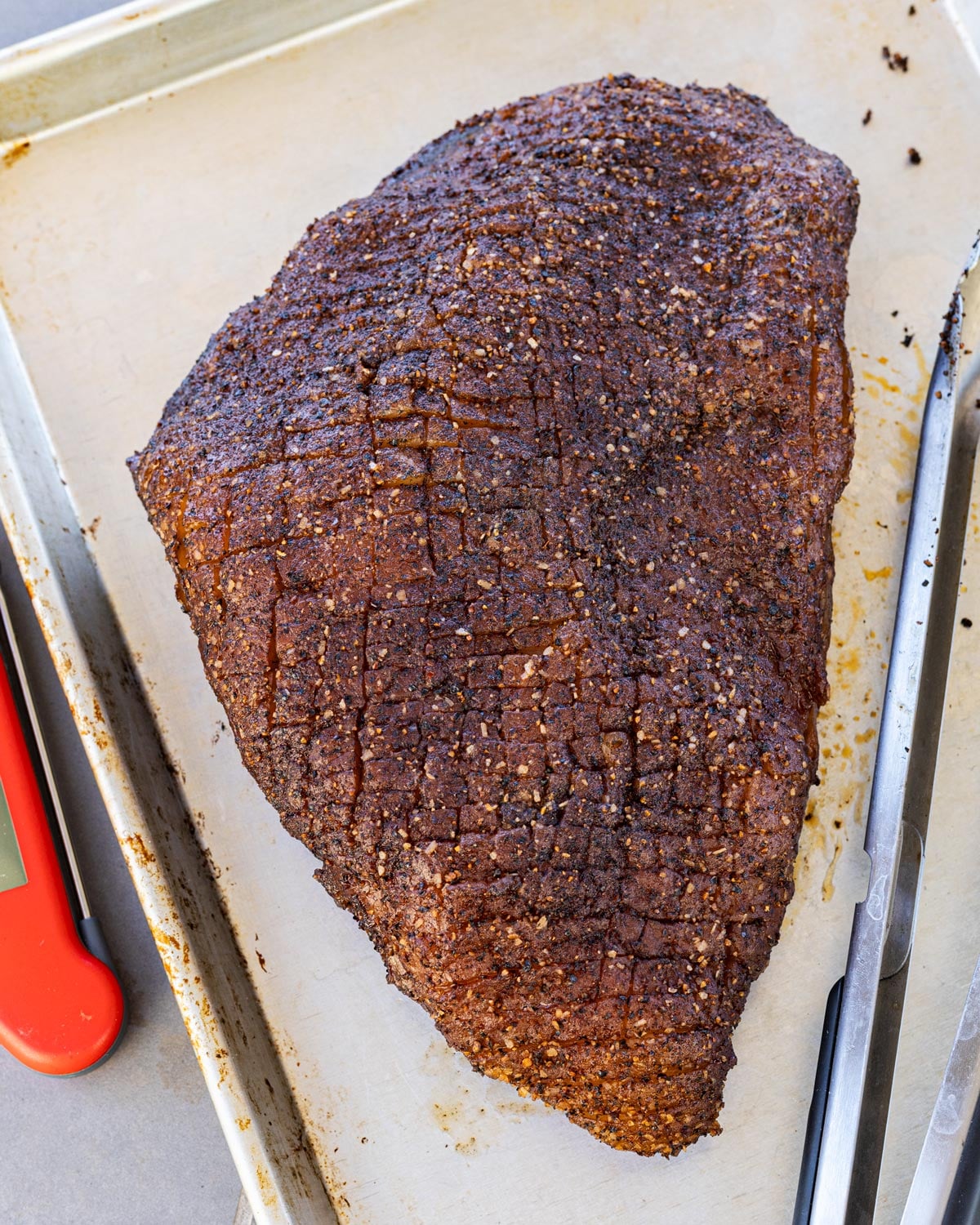 Reverse-seared picanha fat cap showing scored crosshatch after the smoke phase, ready to sear