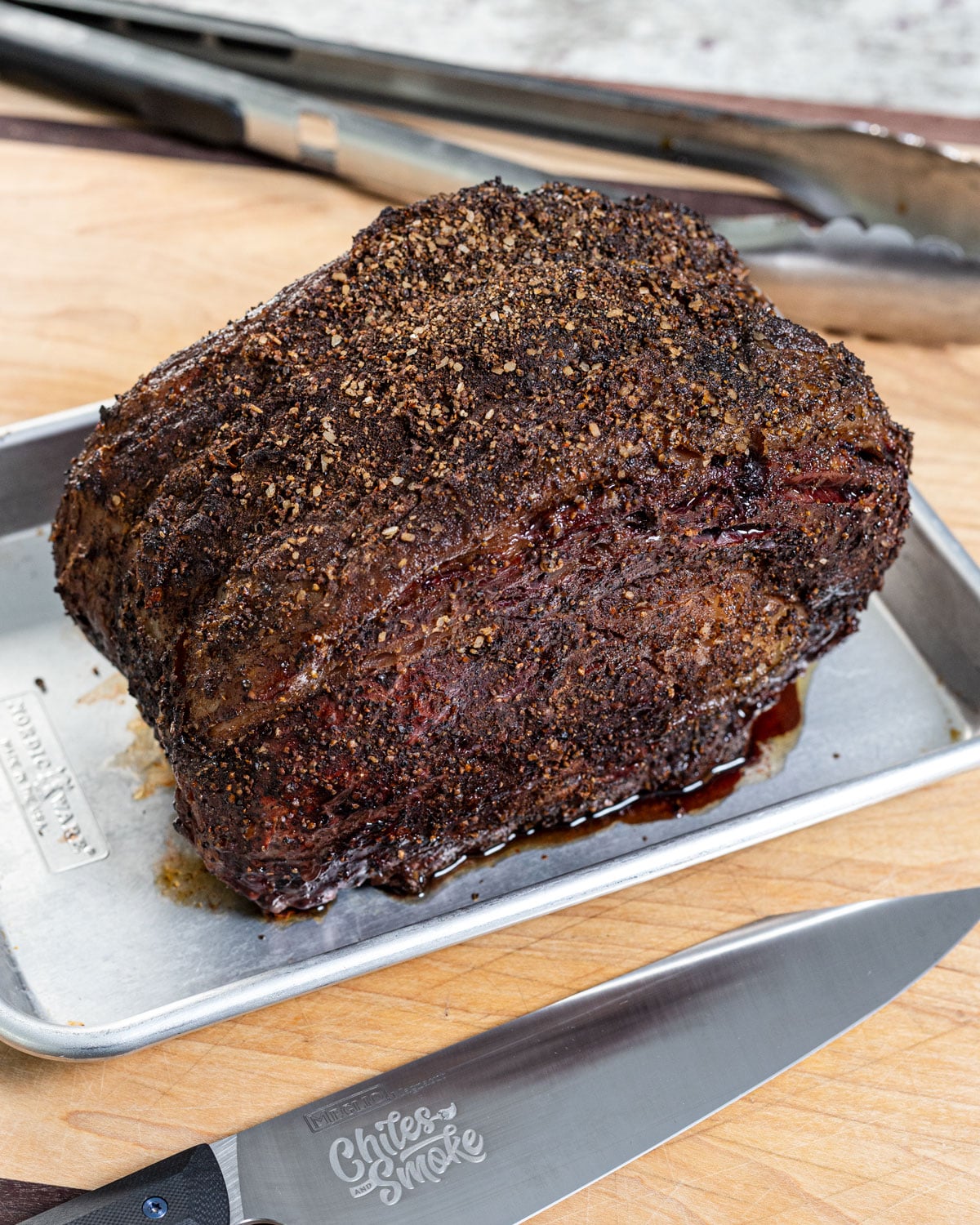 smoked prime rib roast with a deeply browned crust, resting before slicing