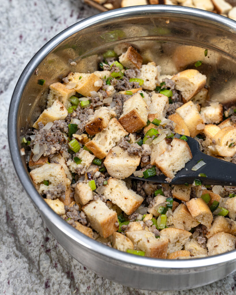Pour in just enough chicken stock to wet the bread cubes, and fold gently.