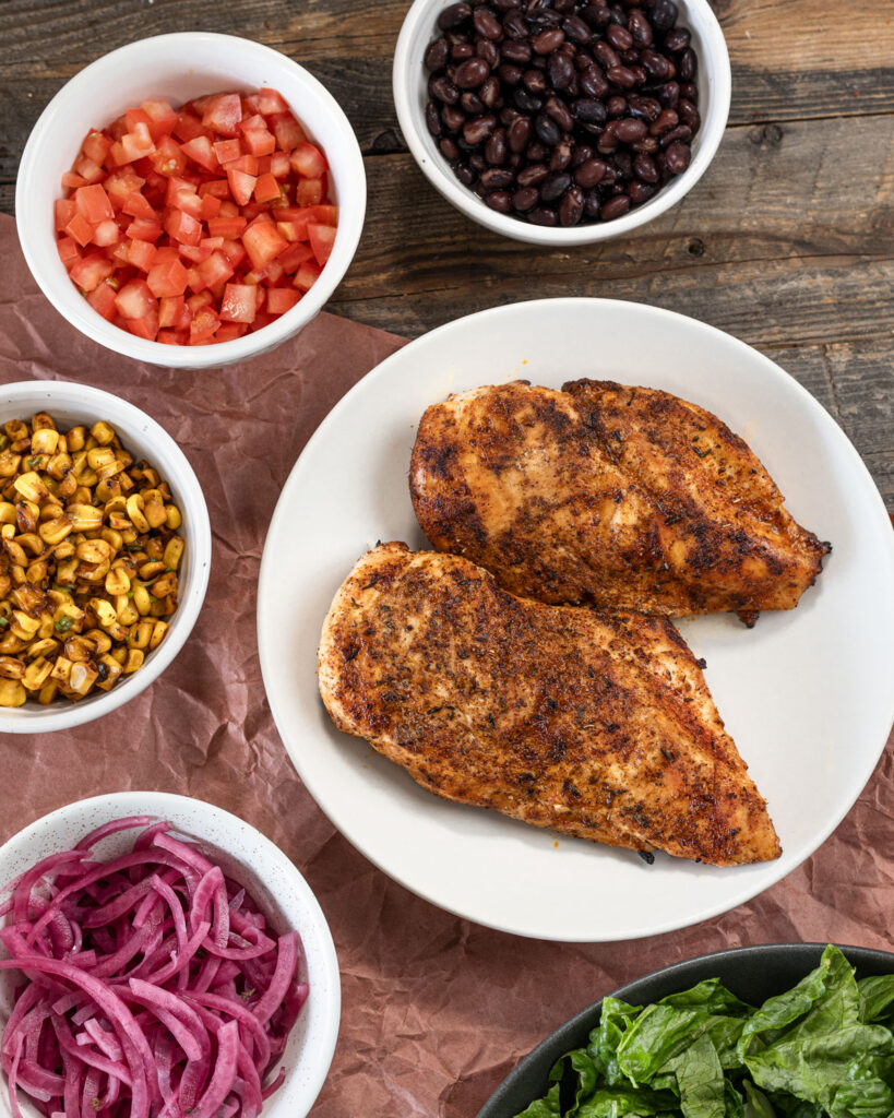 Spicy grilled chicken breast is paired with a variety of exciting toppings for the salad.