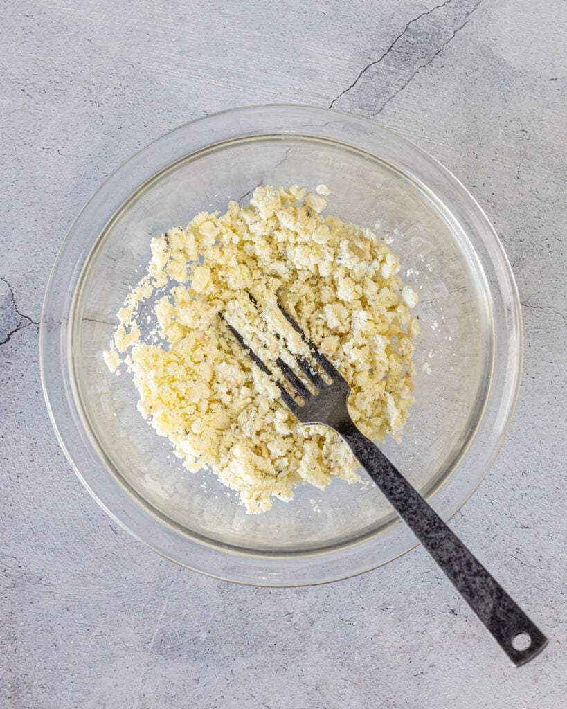 Mash half of the blue cheese in a bowl before adding the rest of the ingredients.