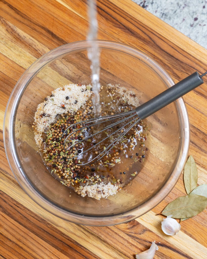 Pour boiling water into the pastrami spices to create the brine.