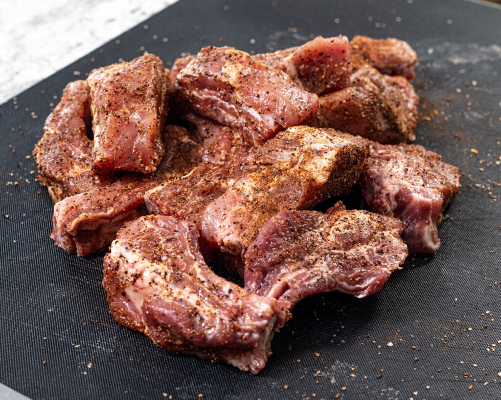 Slice the baby back ribs into individual bones and season generously.