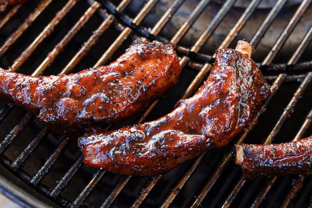 Brush both sides of the baby back ribs with the sauce before finishing.