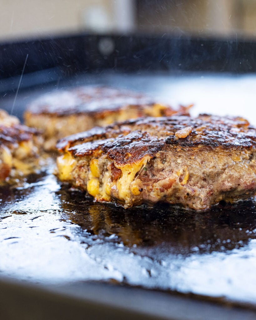 The cheddar cheese forms a crispy cheese skirt on these griddled burgers.