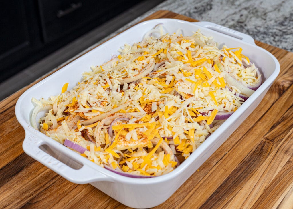 Generously sprinkle the cheese on top of the Vidalia onion casserole before baking.