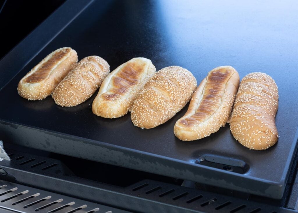 Toast the hoagie rolls on the griddle first to make sure they are ready for sandwiches.