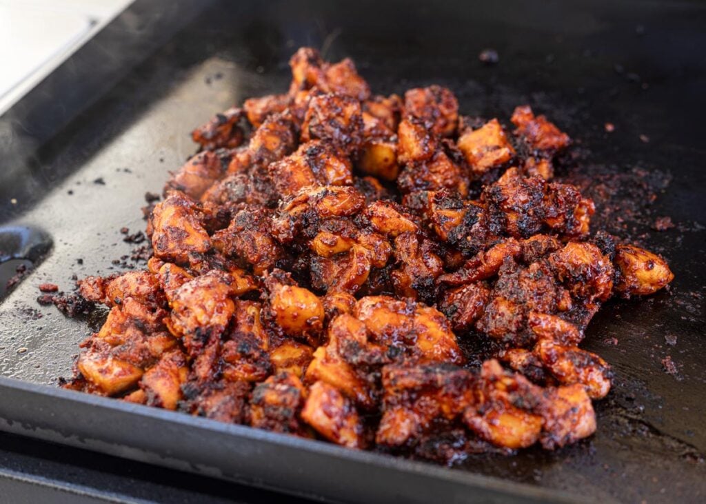 Sear the Korean fire chicken until it's almost fully cooked through.
