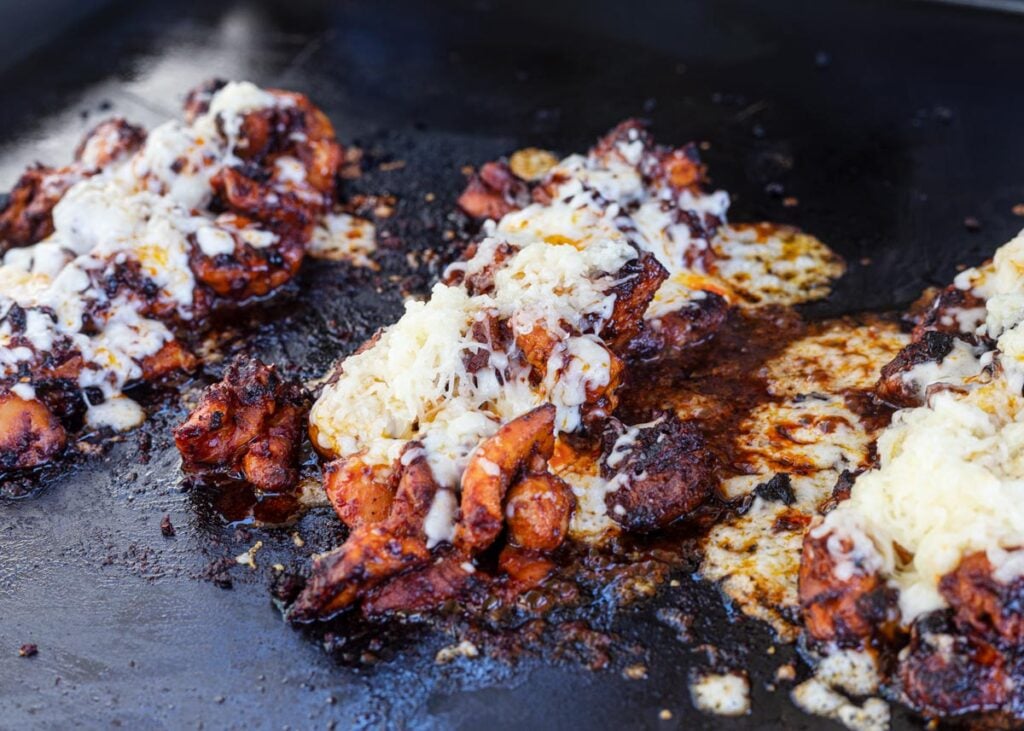 Divide the cooked fire chicken into small piles and top with mozzarella cheese.