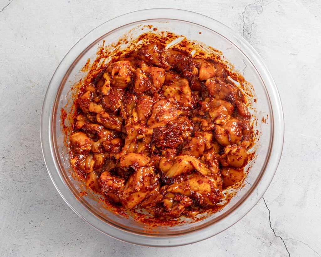 Mix the fire chicken marinade ingredients together and stir in the chicken.
