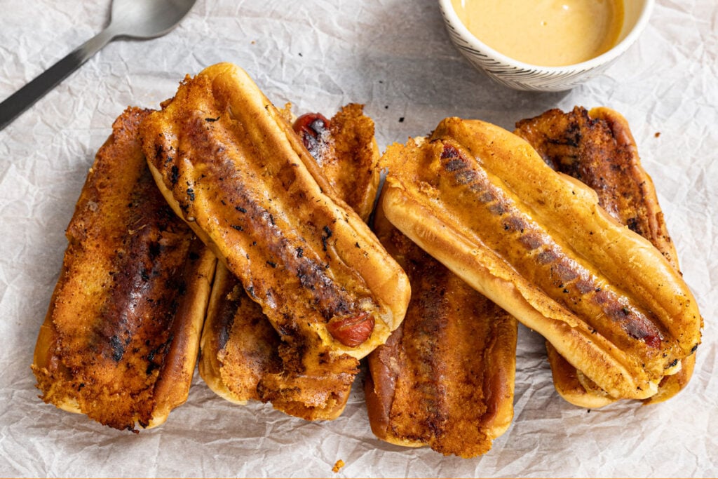 Serving up a plate of crispy grilled cheese hot dogs with a dijon honey mustard.