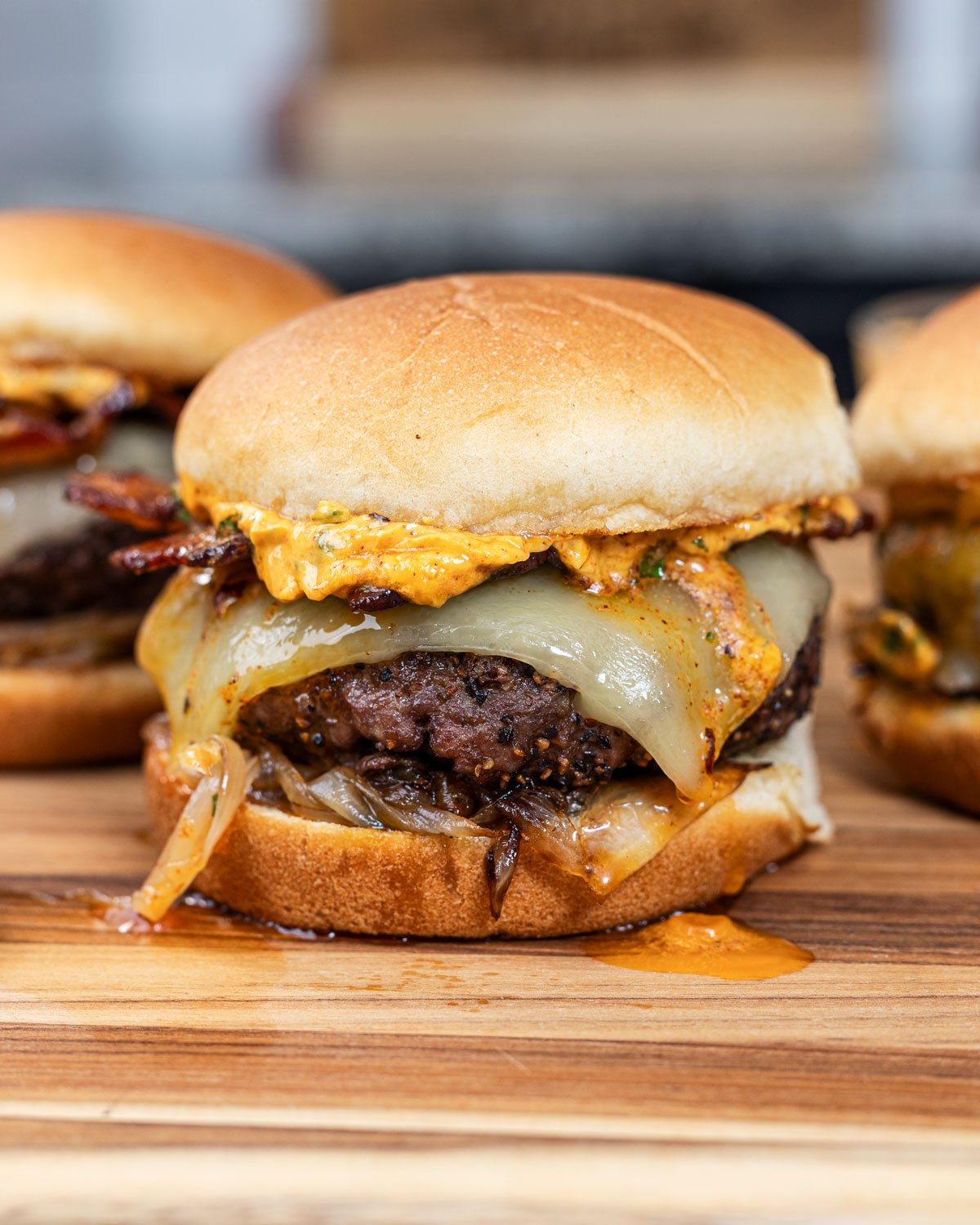 Cowboy butter is dripping down the side of this grilled burger.