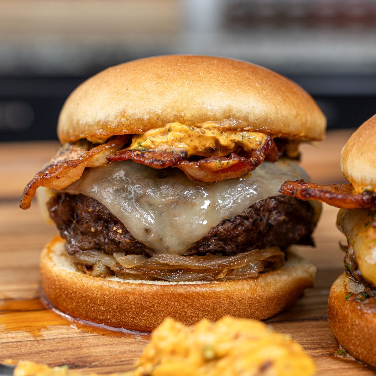 Featuring this grilled bacon burger topped with cowboy butter.