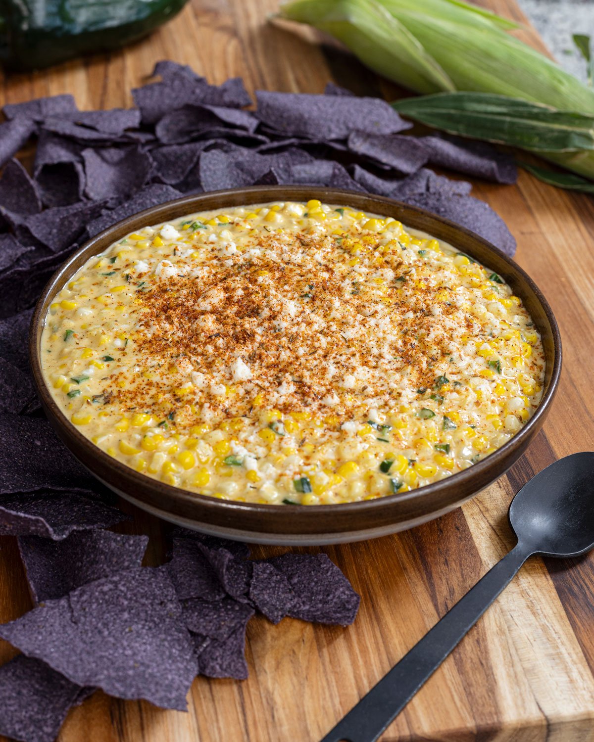 Bowl of Southwest creamed corn topped with cheese and spices