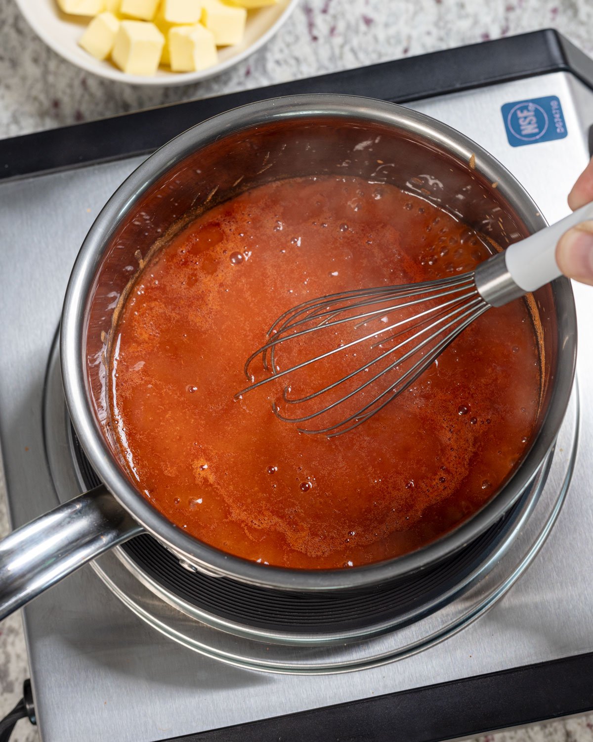 Hot sauce and ingredients warming in a pot.