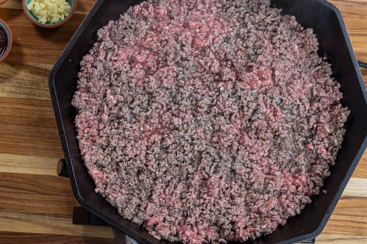 Sear the ground beef in the cast iron skillet first