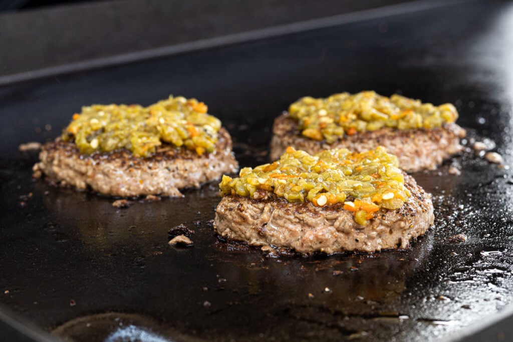 Add Hatch chiles to the top of burgers after flipping.