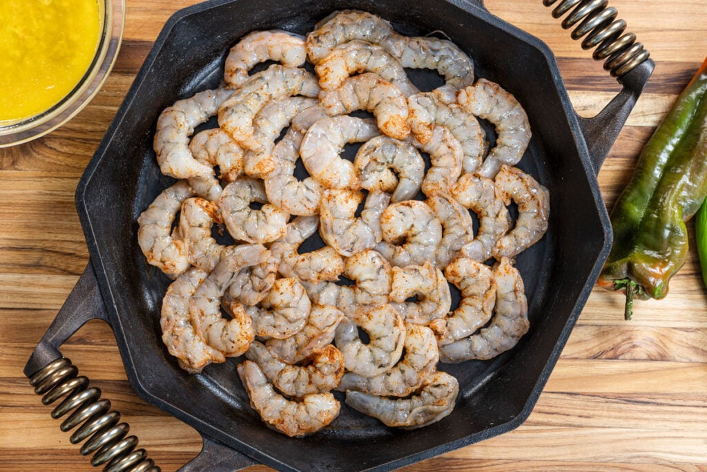 Melted butter is about to be poured over the shrimp skillet.