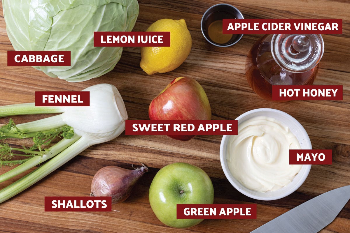 Overhead shot of ingredients needed for fennel apple slaw on a cutting board.