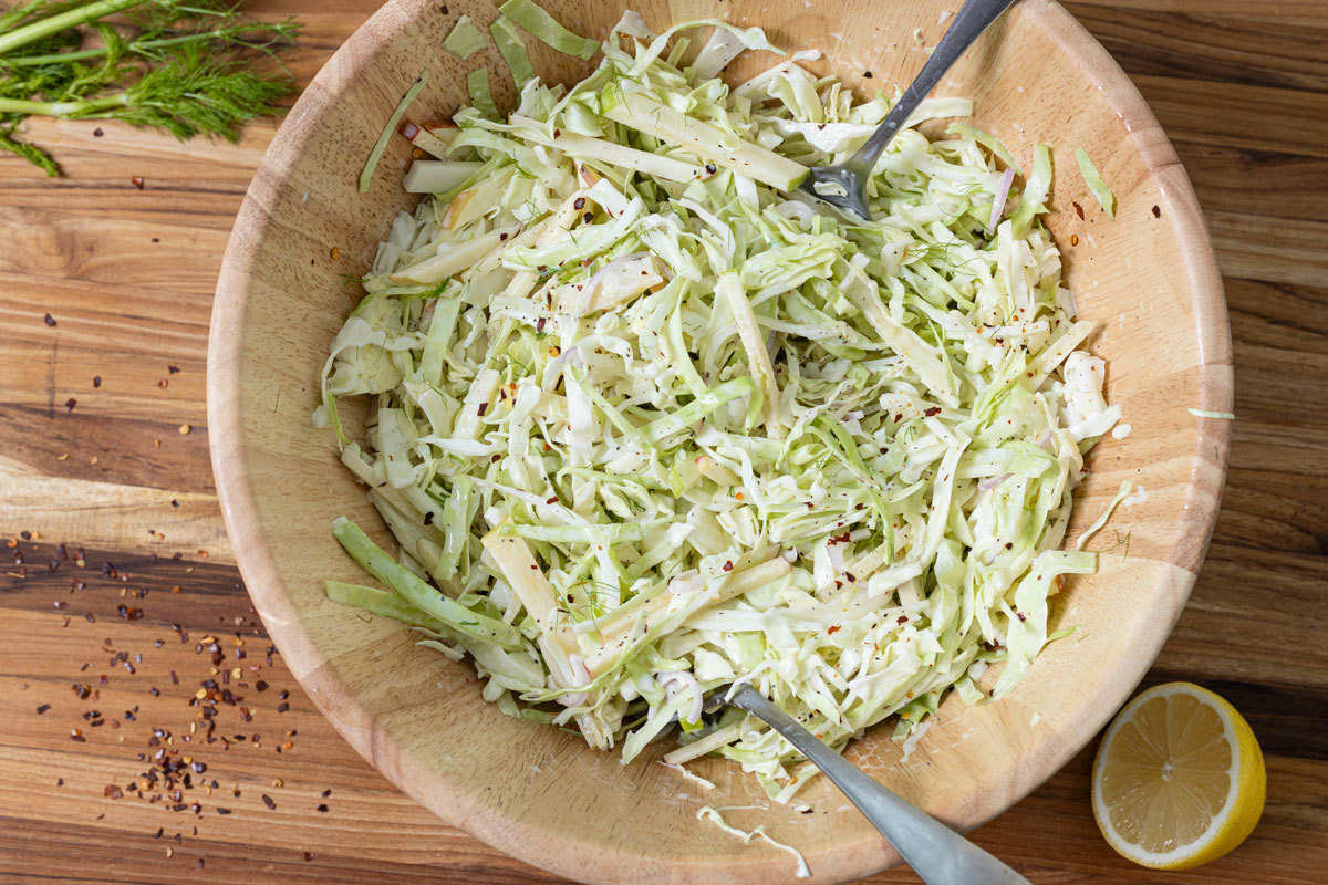 Apple fennel slaw mixed together in a large salad bowl.