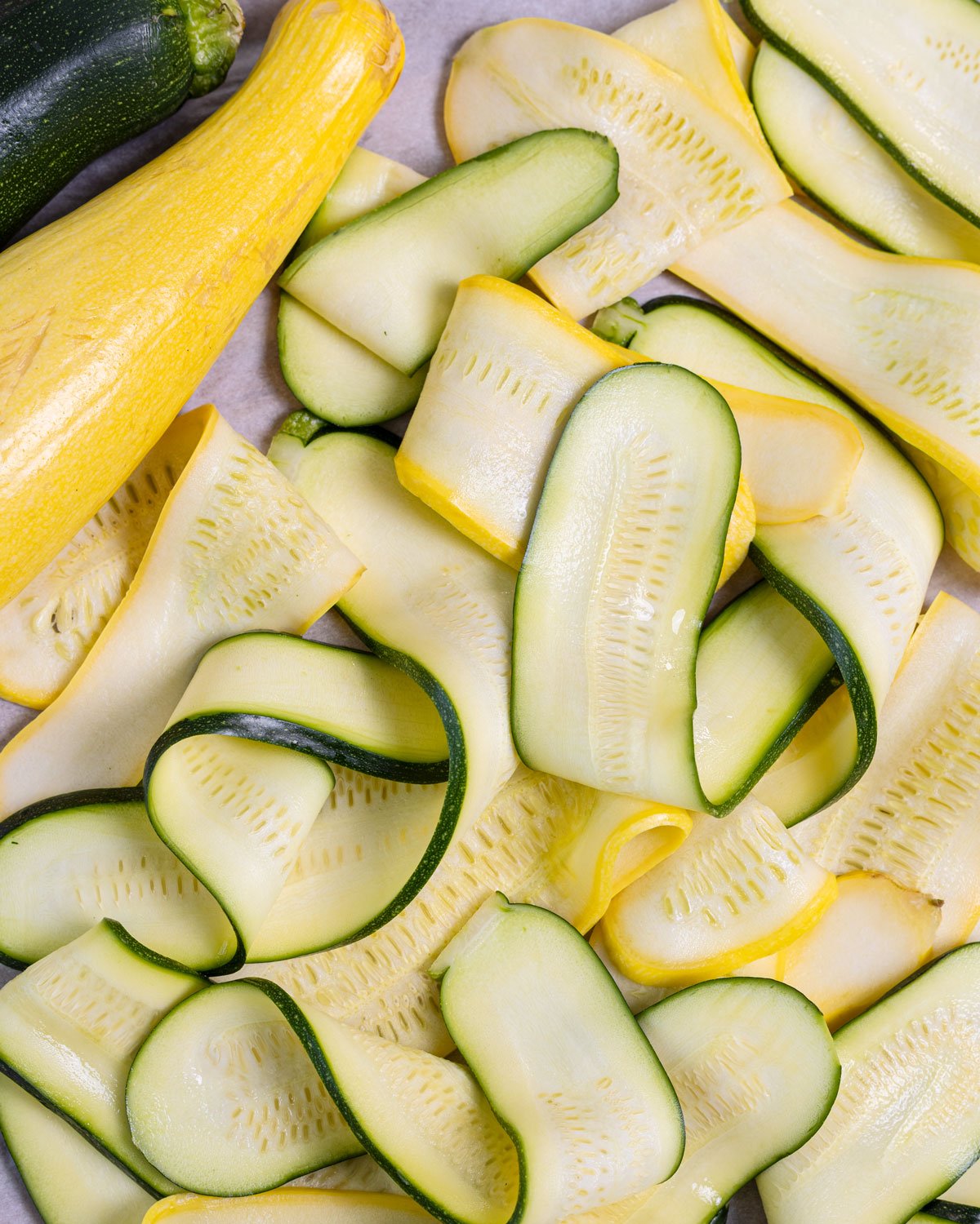 Freshly sliced zucchini and squash ribbons.