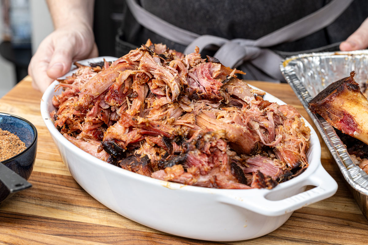 Smoked pulled ham is ready to serve in a white dish