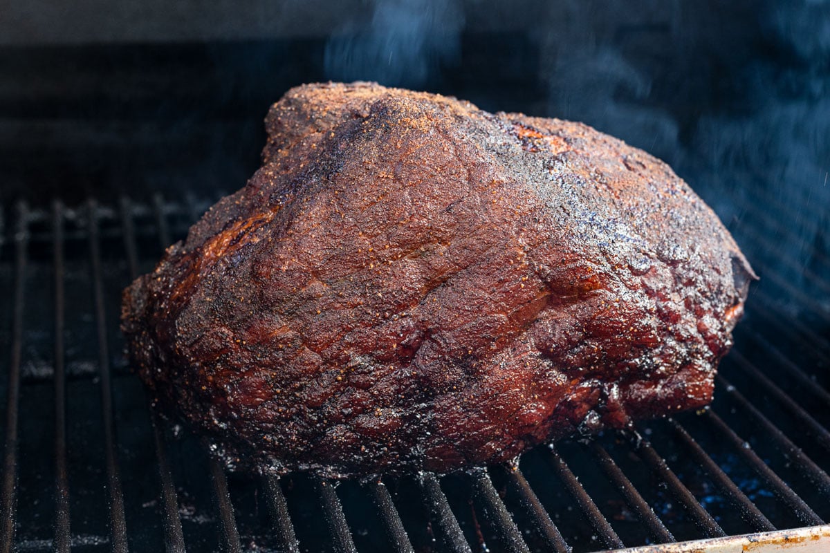 Smoked bone-in ham is in the smoker