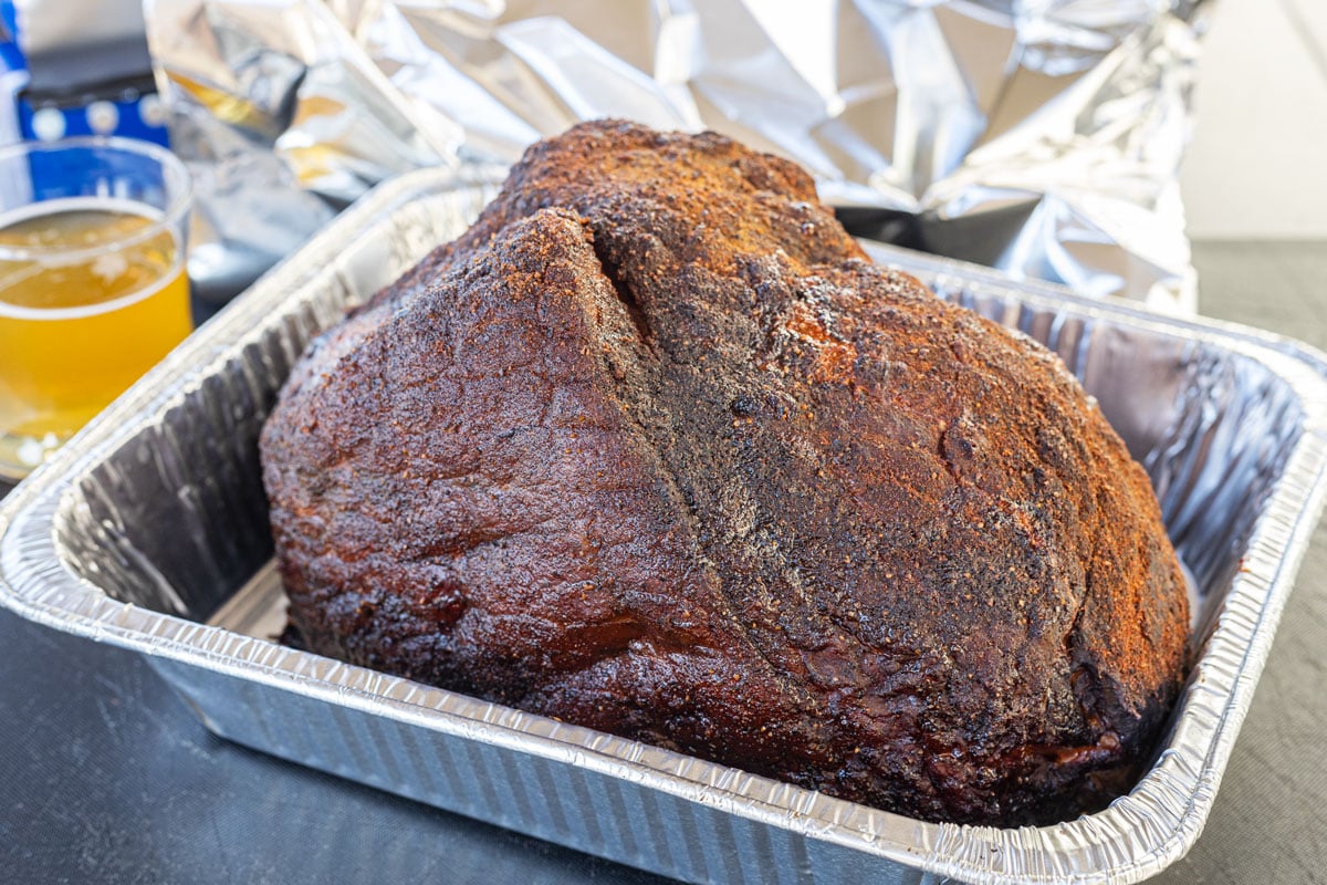 Smoked ham is in a foil fam, ready to be wrapped tight