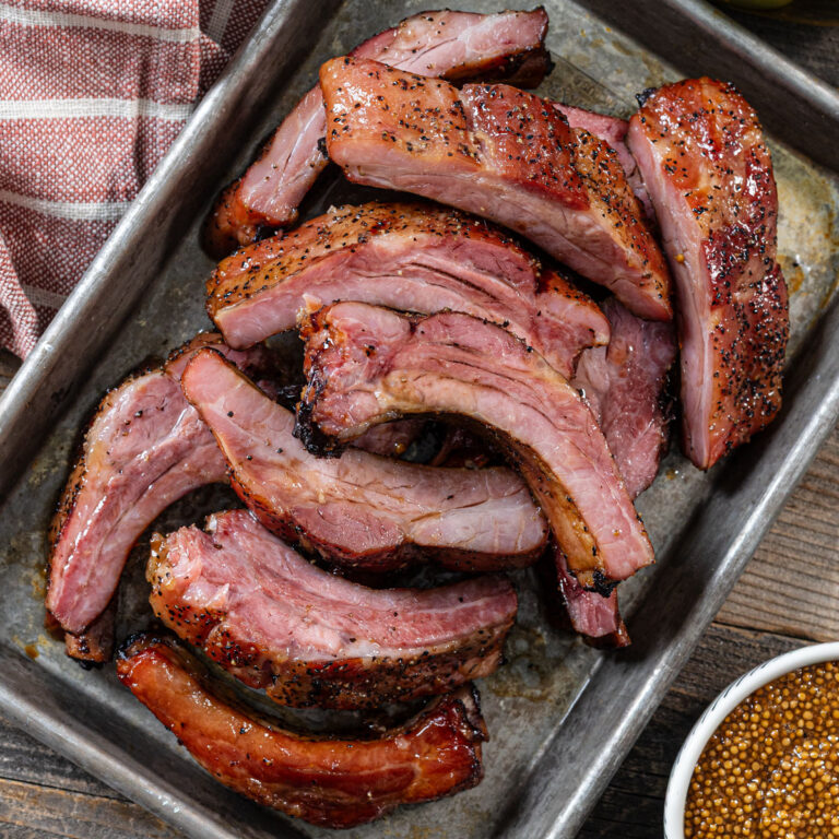 Smoked bacon ribs are featured on a tray